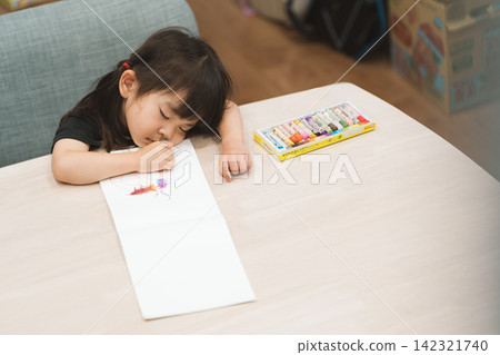 A 3-year-old girl fell asleep at home while coloring. A 3-year-old girl fell asleep at home while coloring. 142321740
