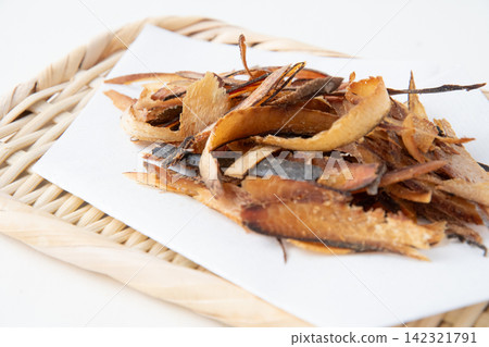 Thickly shaved bonito flakes placed on a sieve Thickly shaved bonito flakes placed on a sieve 142321791