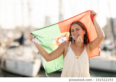 Young woman with Portugal flag in port Young woman with Portugal flag in port 142322243