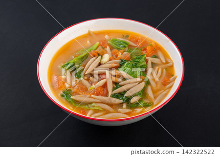 chinese oat noodles fish in tomato soup with leafy green vegetables in a ceramic bowl chinese oat noodles fish in tomato soup with leafy green vegetables in a ceramic bowl 142322522