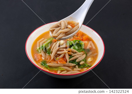 chinese oat noodles fish in tomato soup with leafy green vegetables in a ceramic bowl chinese oat noodles fish in tomato soup with leafy green vegetables in a ceramic bowl 142322524