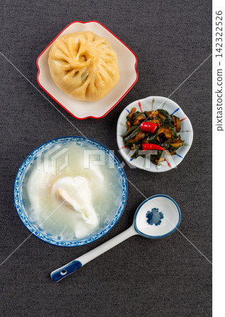 egg drop soup with poached egg steamed baozi and pickled vegetables egg drop soup with poached egg steamed baozi and pickled vegetables 142322526