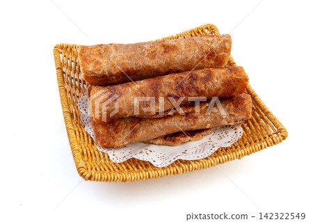 crispy rolled Indian whole wheat flatbread paratha served on a basket crispy rolled Indian whole wheat flatbread paratha served on a basket 142322549