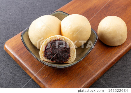 round steamed buns with sweet red bean paste filling on board round steamed buns with sweet red bean paste filling on board 142322684