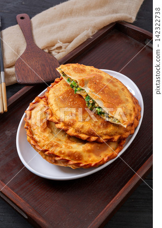 pan fried round flatbread pie stuffed with Chinese chives and egg pan fried round flatbread pie stuffed with Chinese chives and egg 142322738