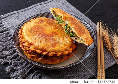 pan fried round flatbread pie stuffed with Chinese chives and egg pan fried round flatbread pie stuffed with Chinese chives and egg 142322739