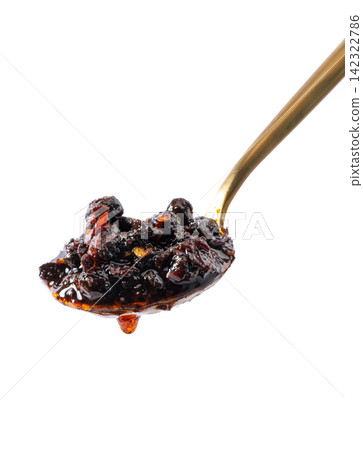 spicy fermented black soybeans condiment with chili oil on golden spoon spicy fermented black soybeans condiment with chili oil on golden spoon 142322786