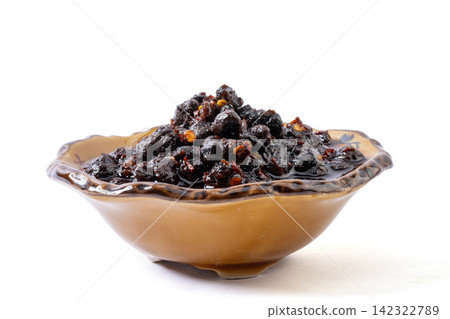 spicy fermented black soybeans condiment with chili oil on golden spoon spicy fermented black soybeans condiment with chili oil on golden spoon 142322789