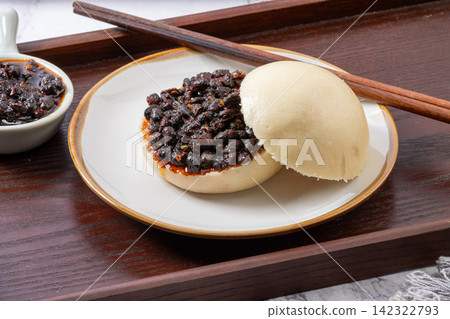 chinese steamed bun sandwich filled with spicy fermented black bean relish chinese steamed bun sandwich filled with spicy fermented black bean relish 142322793