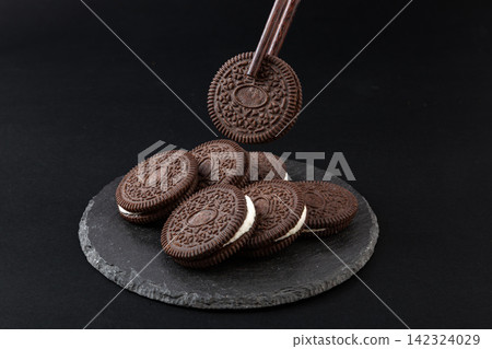 tower Stack of Dark Cocoa Cream Sandwich Cookies 142324029