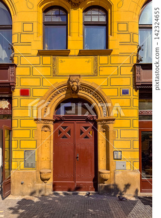 Building with yellow walls and detailed door design in Prague Building with yellow walls and detailed door design in Prague 142324655