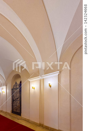Architectural details of a hallway with arches and light fixtures Architectural details of a hallway with arches and light fixtures 142324668