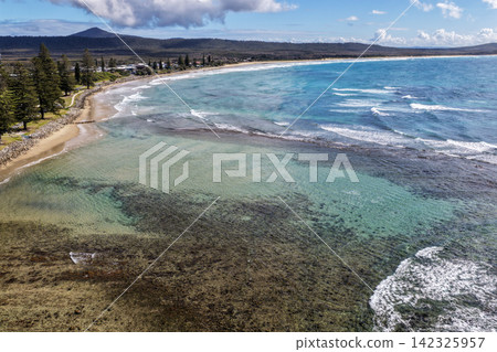 Aerial view of the rockpool and surrounding coastline at Brooms Head, featuring clear ocean water, rugged rock formations and the natural coastal landscape along the Clarence Valley coast of NSW Aerial view of the rockpool and surrounding coastline at Brooms Head, featuring clear ocean water, rugged rock formations and the natural coastal landscape along the Clarence Valley coast of NSW 142325957