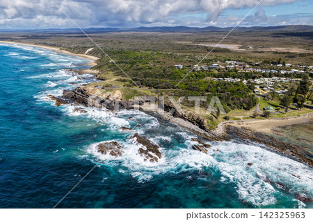 Aerial view of Brooms Head, Brooms Head Beach and Sand Dune Beach, showcasing the headland, long sandy shorelines, Pacific Ocean and surrounding natural coastal landscape in the Clarence Valley region Aerial view of Brooms Head, Brooms Head Beach and Sand Dune Beach, showcasing the headland, long sandy shorelines, Pacific Ocean and surrounding natural coastal landscape in the Clarence Valley region 142325963