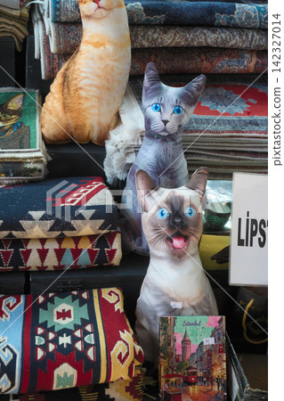 Cat-shaped cushions and Turkish carpets lined up in souvenir shops in Istanbul Cat-shaped cushions and Turkish carpets lined up in souvenir shops in Istanbul 142327014