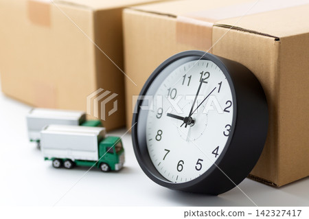 Cardboard boxes, a clock, and a truck Cardboard boxes, a clock, and a truck 142327417