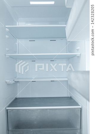 Refrigerator with empty shelves showcases clean lines and minimal design Refrigerator with empty shelves showcases clean lines and minimal design 142328205