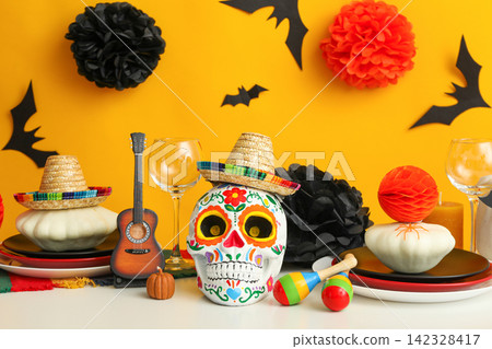 Halloween. Table set for Halloween party featuring skull and decorative elements Halloween. Table set for Halloween party featuring skull and decorative elements 142328417