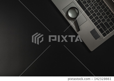Magnifying glass on laptop for detailed investigation and research tasks Magnifying glass on laptop for detailed investigation and research tasks 142328661