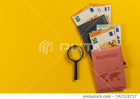 Travel budget planning with passport and euro banknotes on a yellow table Travel budget planning with passport and euro banknotes on a yellow table 142328717