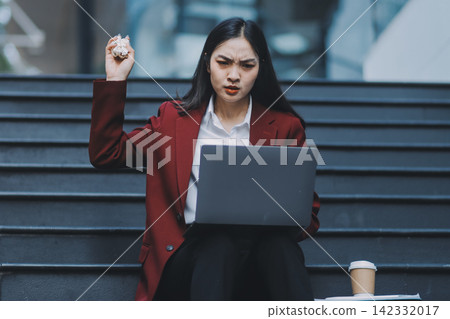 Asian woman in sitting at stairway outdoor have a stressed, after being laid off unemployed. Desperate be out of work. Asian woman in sitting at stairway outdoor have a stressed, after being laid off unemployed. Desperate be out of work. 142332017
