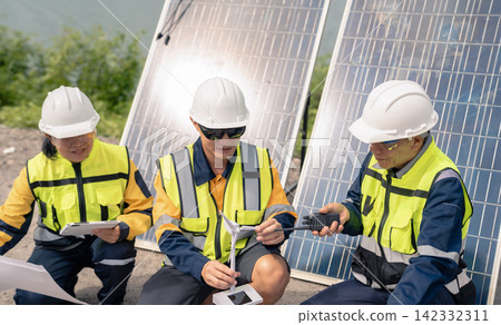 Architect team working with blueprints for sketching a construction project, green energy and solar panel concept. Architect team working with blueprints for sketching a construction project, green energy and solar panel concept. 142332311