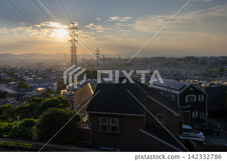 Evening view of a residential area and power transmission towers in the suburbs of Hino City, Tokyo. Evening view of a residential area and power transmission towers in the suburbs of Hino City, Tokyo. 142332786