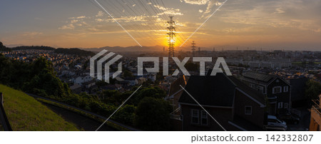 Evening view of a residential area and power transmission towers in the suburbs of Hino City, Tokyo. 142332807