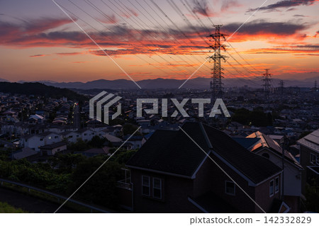 Evening view of a residential area and power transmission towers in the suburbs of Hino City, Tokyo. Evening view of a residential area and power transmission towers in the suburbs of Hino City, Tokyo. 142332829