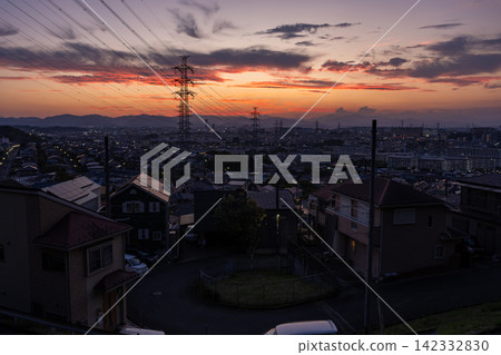 Evening view of a residential area and power transmission towers in the suburbs of Hino City, Tokyo. Evening view of a residential area and power transmission towers in the suburbs of Hino City, Tokyo. 142332830