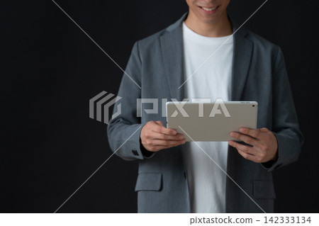 A young male engineer against a black background A young male engineer against a black background 142333134