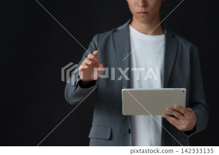 A young male engineer against a black background A young male engineer against a black background 142333135