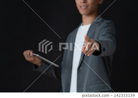 一位年輕的男工程師，背景是黑色。 142333139