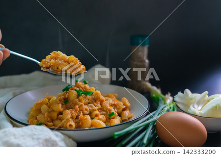 The aroma in the spoon is fried macaroni with egg and on top spring onion with raw onion. Vegetarian food for non-meat eaters. The aroma in the spoon is fried macaroni with egg and on top spring onion with raw onion. Vegetarian food for non-meat eaters. 142333200