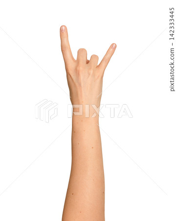 Female right hand throws up a hard rock sign. Index and little finger point up while others curl Female right hand throws up a hard rock sign. Index and little finger point up while others curl 142333445