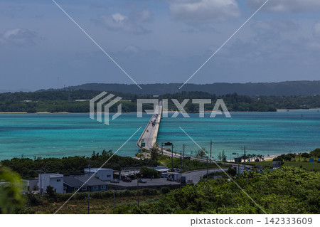 A view of the blue sea and coastline overlooking Kouri Bridge and Yagaji Island in Okinawa Prefecture, Japan. A view of the blue sea and coastline overlooking Kouri Bridge and Yagaji Island in Okinawa Prefecture, Japan. 142333609