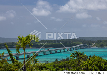 A view of the blue sea and coastline overlooking Kouri Bridge and Yagaji Island in Okinawa Prefecture, Japan. A view of the blue sea and coastline overlooking Kouri Bridge and Yagaji Island in Okinawa Prefecture, Japan. 142333611