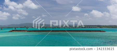 A view of the blue sea and coastline overlooking Kouri Bridge and Yagaji Island in Okinawa Prefecture, Japan. A view of the blue sea and coastline overlooking Kouri Bridge and Yagaji Island in Okinawa Prefecture, Japan. 142333615