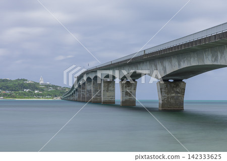 A view of the blue sea and coastline overlooking Kouri Bridge and Kouri Island in Okinawa Prefecture, Japan. A view of the blue sea and coastline overlooking Kouri Bridge and Kouri Island in Okinawa Prefecture, Japan. 142333625