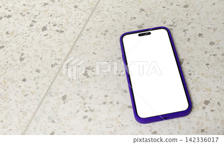 A smartphone with a blank white screen lies diagonally on a terrazzo tile floor, photographed from A smartphone with a blank white screen lies diagonally on a terrazzo tile floor, photographed from 142336017