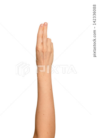 Index and middle fingers raised in a peace-like gesture. Woman s hand showing two extended fingers Index and middle fingers raised in a peace-like gesture. Woman s hand showing two extended fingers 142336088