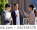 A woman conducting a street interview and a man answering her questions. 142336176