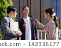 A female reporter conducting an interview and a businessman answering her questions. 142336177