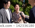 A woman smiles as she answers questions in a street interview. 142336180