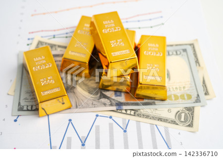 Gold bars on US dollar banknote money, finance trading investment business currency. 142336710