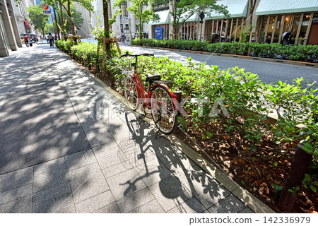 A bicycle parked on Nihonbashi Edozakura Street, bathed in the afternoon sun. A bicycle parked on Nihonbashi Edozakura Street, bathed in the afternoon sun. 142336979