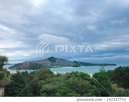 在陰雲密佈的天空下，海面上漂浮著島嶼。 142337732