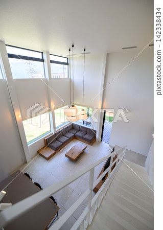 A modern living room with large windows and a sofa. A modern living room with large windows and a sofa. 142338434