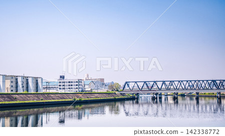 藍天下的桁架橋和河岸景色。 藍天下的桁架橋和河岸景色。 142338772