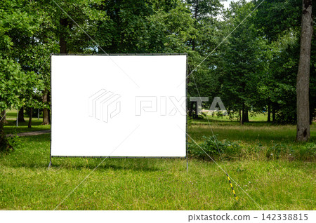 Billboard mockup template in a green park under a clear sky Billboard mockup template in a green park under a clear sky 142338815